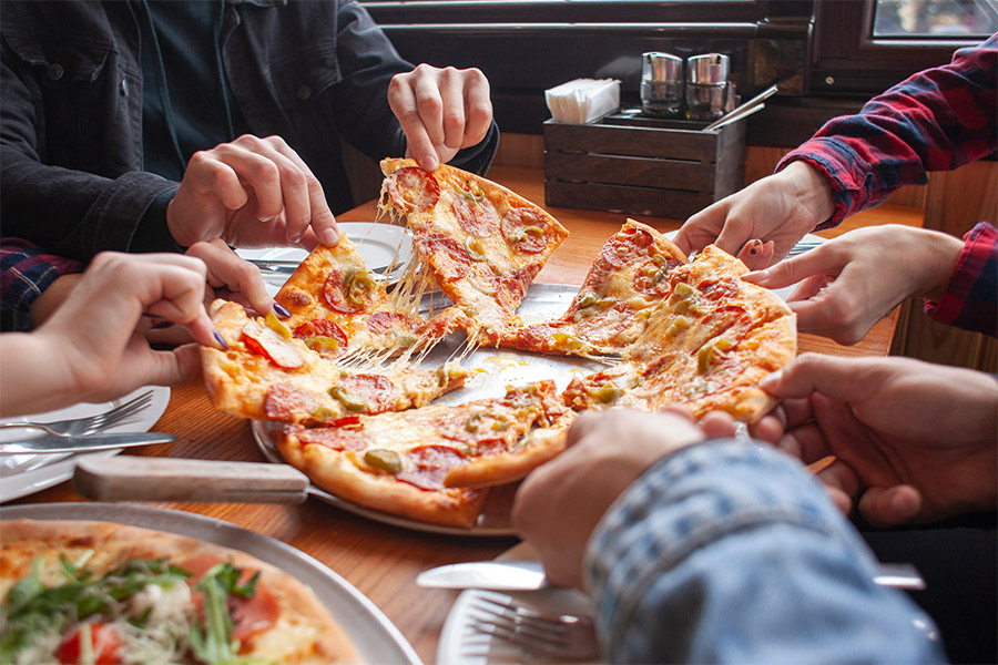 Group enjoying local pizza